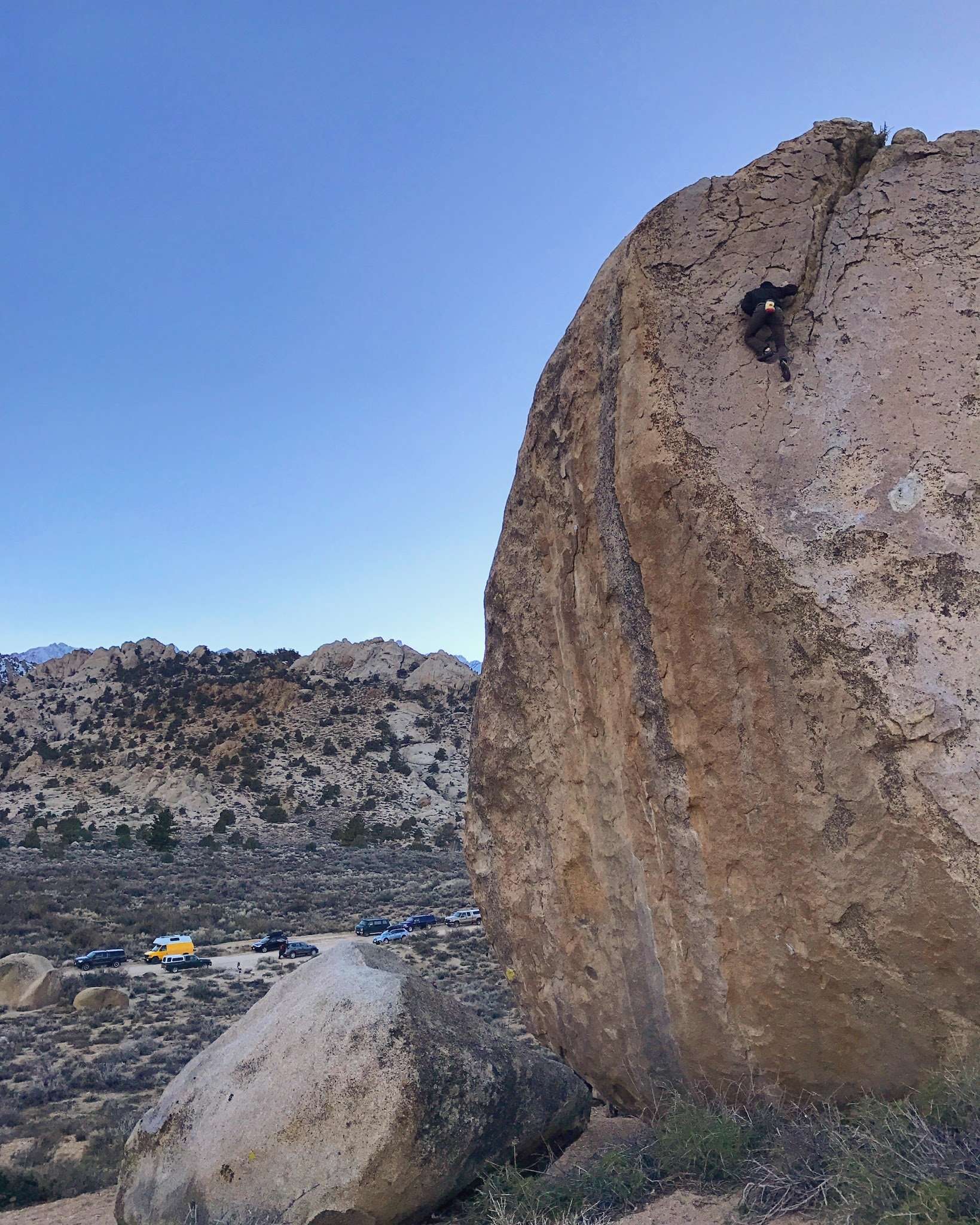 Itai, nearing the top of East Arete (5.10) as the sun sets on the Milks.